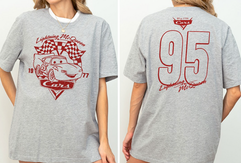 A grey t-shirt with a red graphic design featuring a car and the text "Lightning McQueen" and "Cars" printed on it.