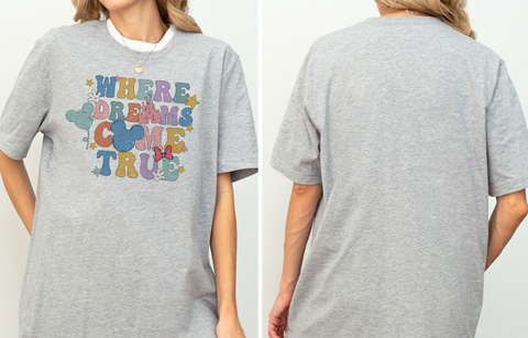 A gray t-shirt with a colorful graphic design featuring the text "WHERE DREAMS COME TRUE" and various Disney-themed elements such as Mickey Mouse and clouds.