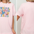 A woman wearing a pink t-shirt with the text "WHERE DREAMS COME TRUE" printed on it.