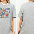 A gray t-shirt with a colorful graphic design featuring the text "WHERE DREAMS COME TRUE" and various Disney-themed elements such as Mickey Mouse and clouds.