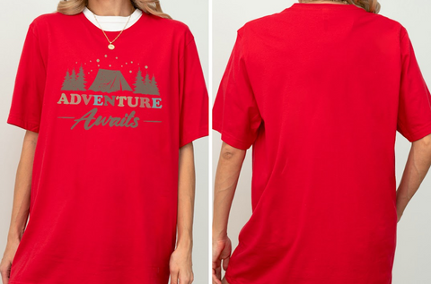 A red t-shirt with the text "ADVENTURE Awaits" printed on it, along with a graphic of a tent and trees.