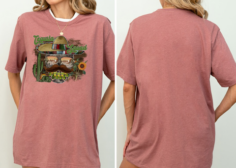 A woman wearing a pink t-shirt with a graphic design featuring a sombrero, sunglasses, and a cactus.