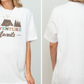 A white t-shirt with a graphic design that says "Adventure Awaits" on it.