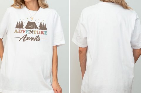 A white t-shirt with a graphic design that says "Adventure Awaits" on it.